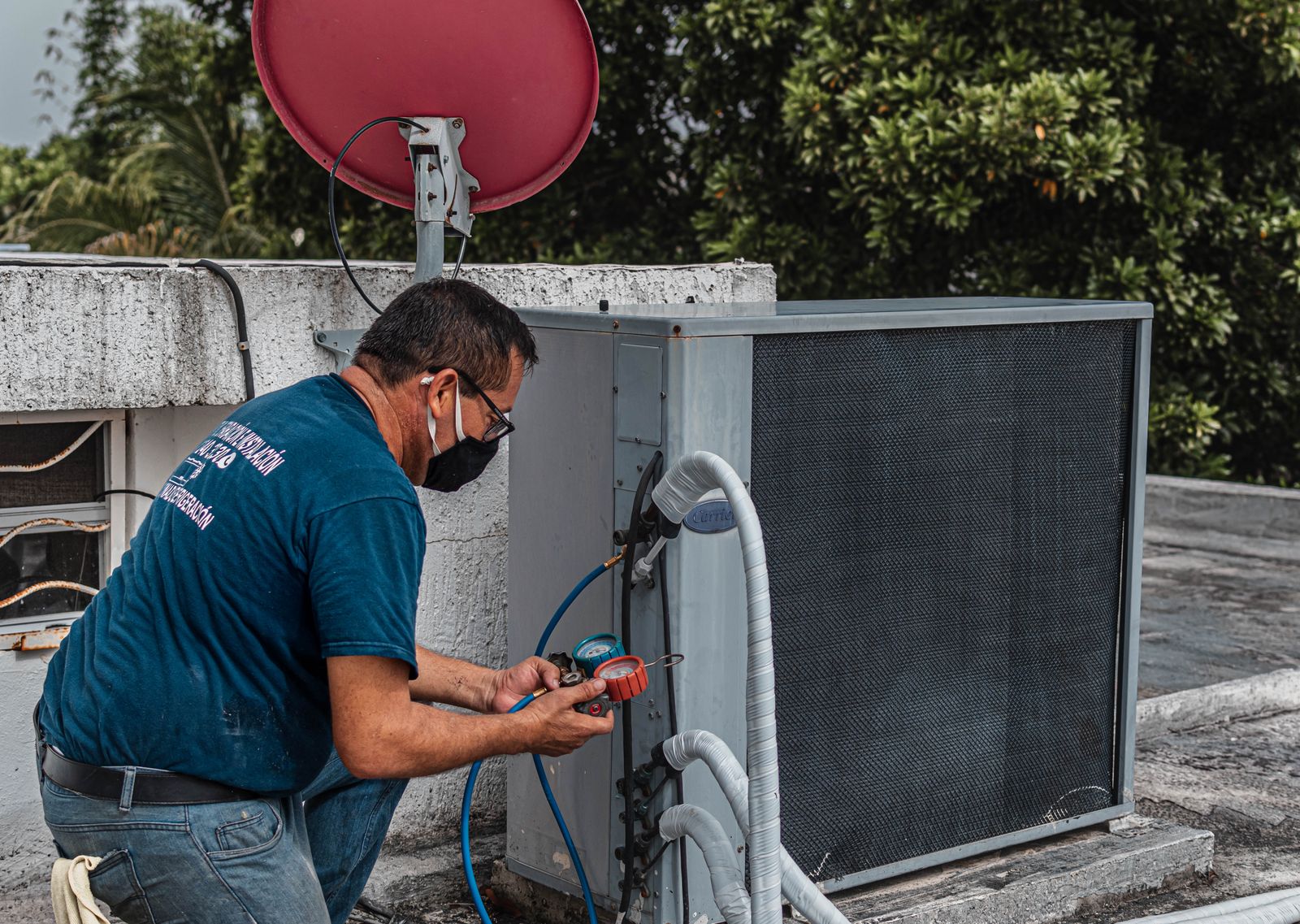 A trade professional checking outdoor air-conditioning equipment
